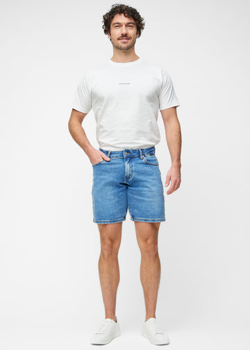 Full image of a model wearing blue denim shorts for men in the colour Rivers with a regular fit.