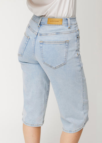Close-up back view of loose, light blue Waves denim capris, showing the fit and details.
