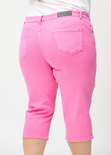 Light pink regular capris seen from the back close up on a plus-size model to show details.