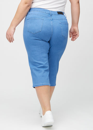 Blue regular capris seen from the back on a plus-size model, so the entire product can be seen.