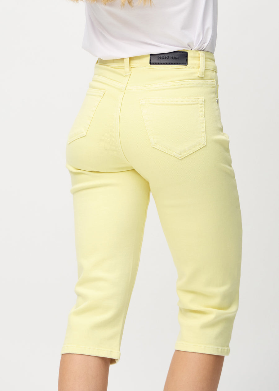 Light yellow regular capris seen from the back close up to show details.