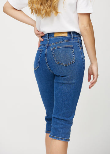 Dark denim regular capris seen from the back close up to show details.