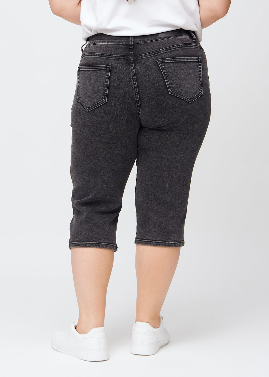 Dark grey denim regular capris seen from the back on a plus-size model, so the full product can be seen.