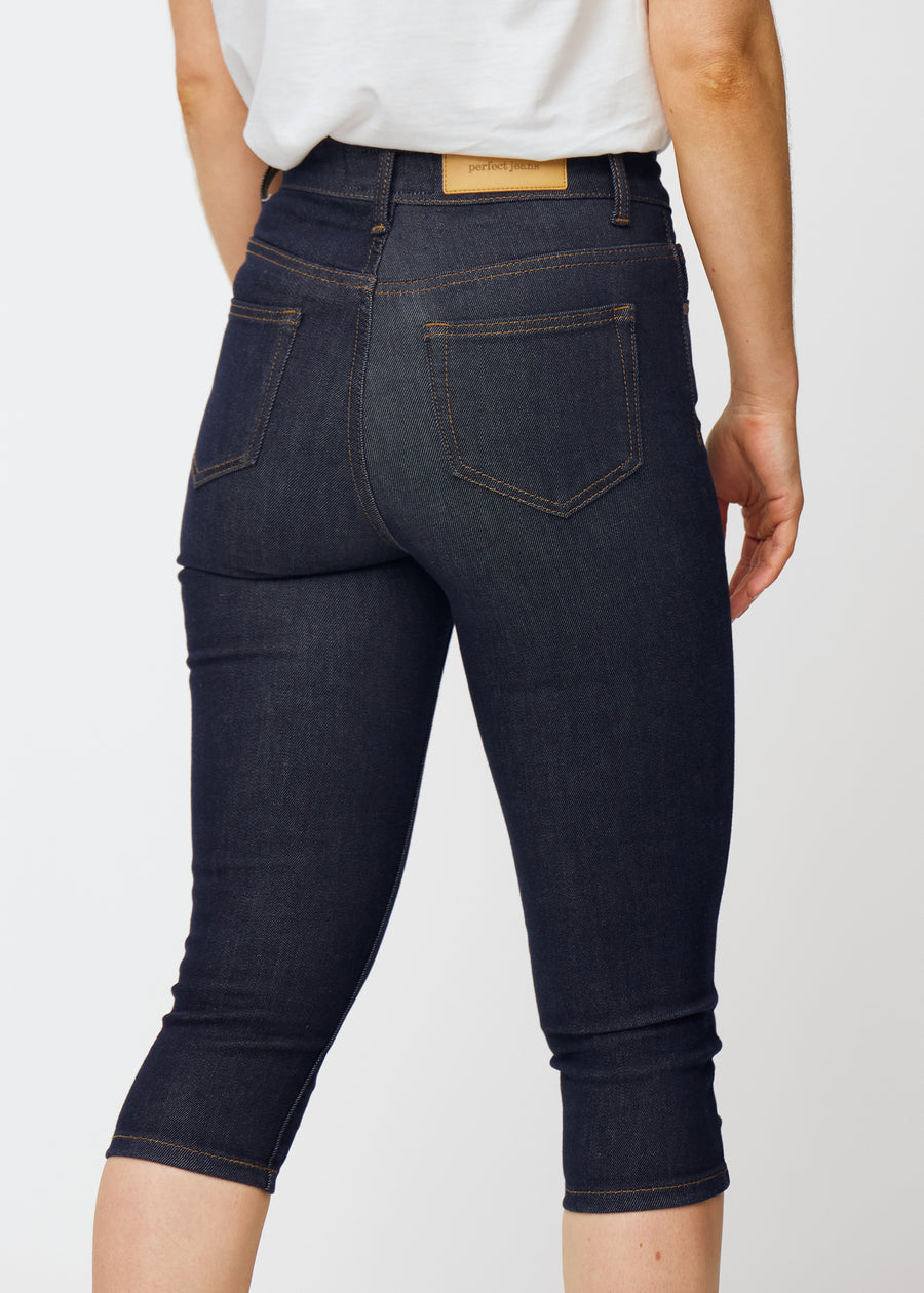 Deep dark blue denim capris for women in the colour Midnights seen from the back in close-up to show fit and details.
