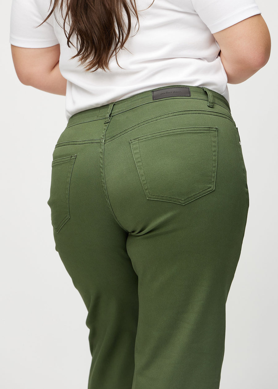 Dark green loose jeans seen from the back close up on a plus-size model to show details.