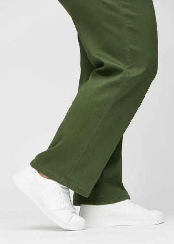 The ankles of a plus-size model, so you can see how loose the jeans fit.
