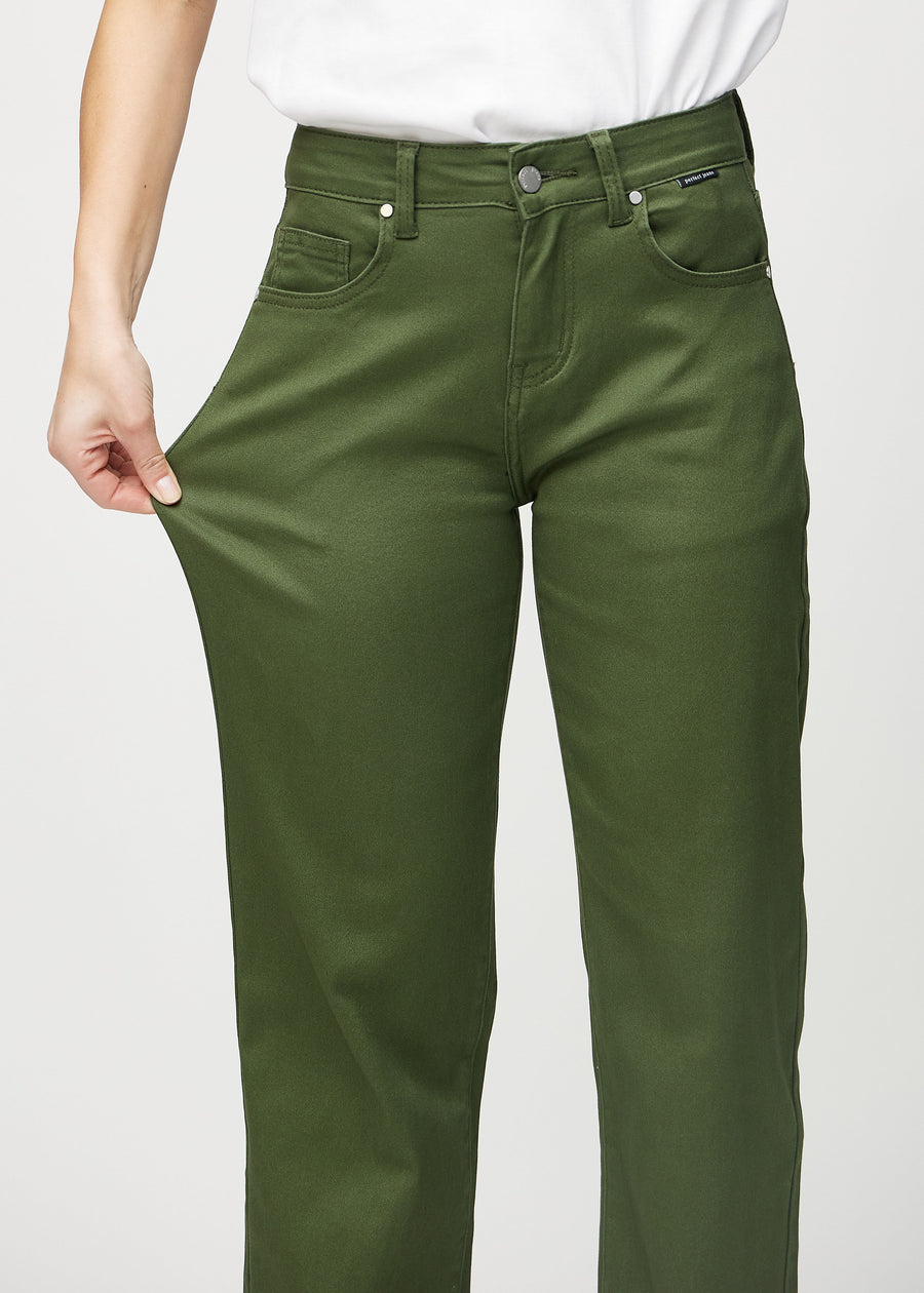 The model stretches the jeans at the thigh to show the stretch.