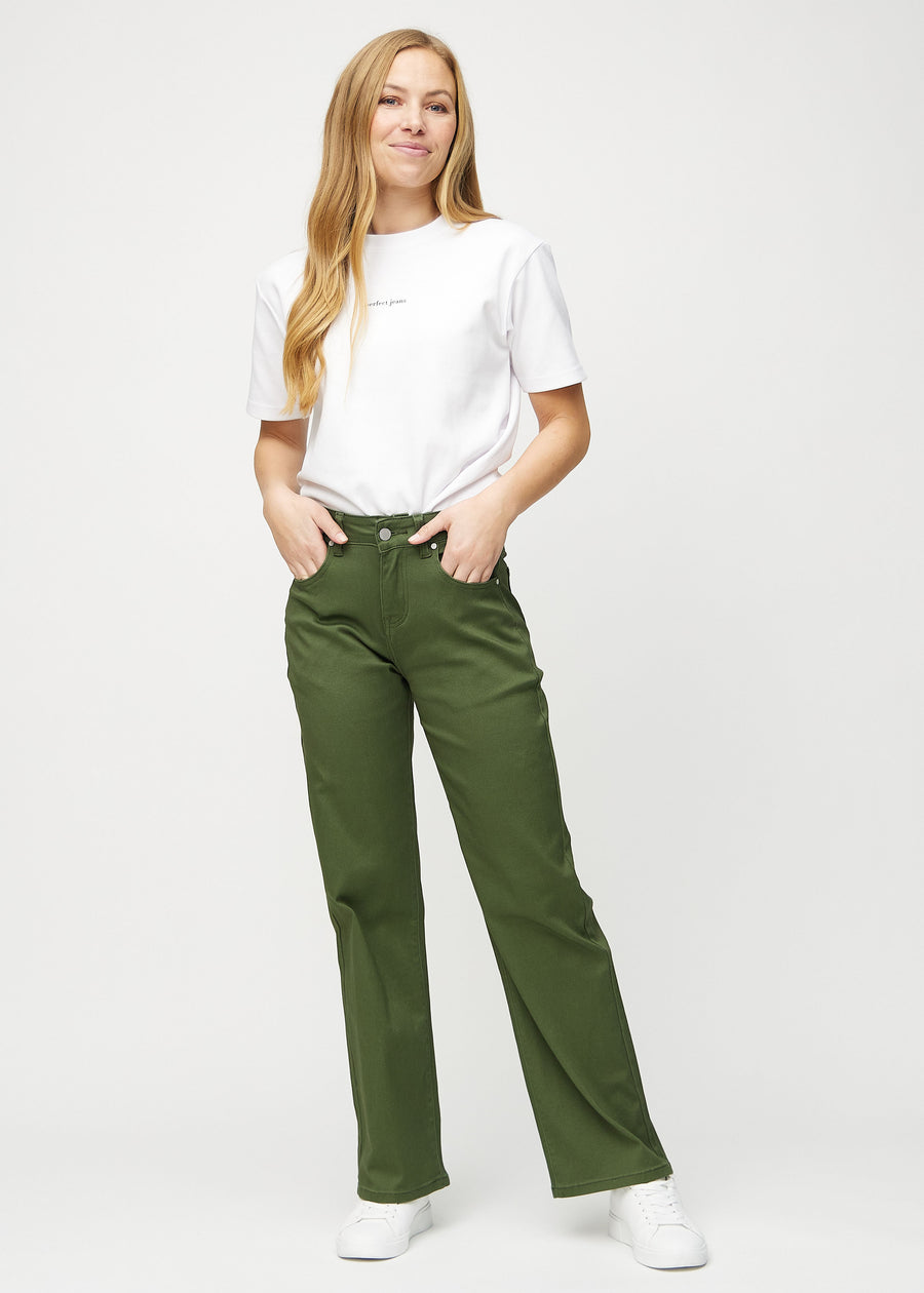 Full image of model in dark green loose jeans.