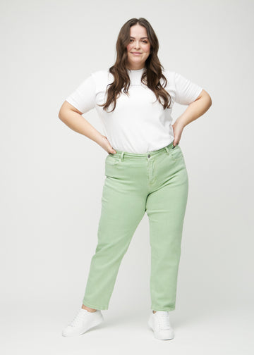 Regular jeans for women in light green, color Mints. Full-length view of a plus-size model wearing the jeans.