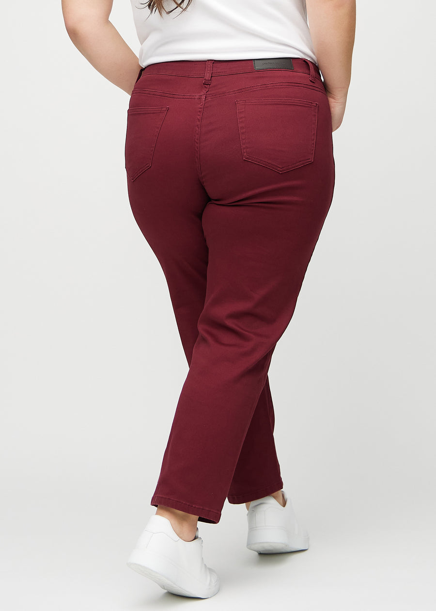 Regular jeans for women in dark red, color Santas. Back view on a plus-size model, showing the full fit.