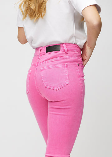 Skinny jeans for women in light pink, color Flamingos. Close-up back view on a model, showing details.