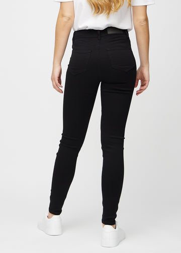 Skinny jeans for women in black, color Ravens. Back view on a model, showing the overall fit.