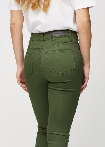 Skinny jeans for women in dark green, color Renewals. Close-up back view on a model, showing the details.