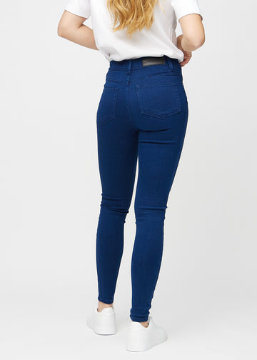 Skinny jeans for women in dark blue, color Royals. Back view on a model, showing the overall fit.
