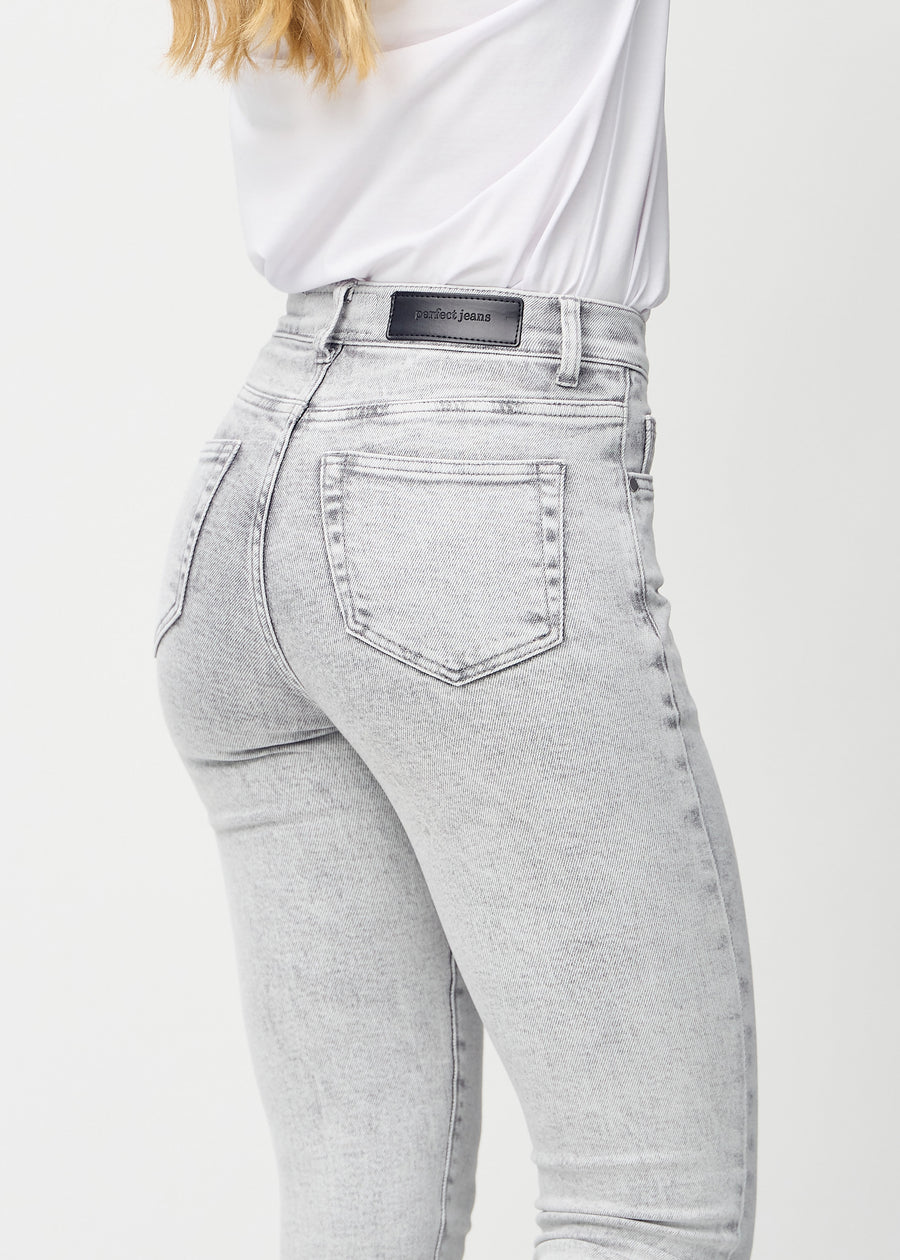 Slim jeans for women in light grey, color Ashes. Close-up back view on a model, showing the details.