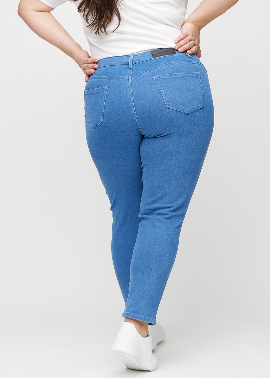 Slim jeans for women in blue, color Geraniums. Back view on a plus-size model, showing the overall fit.