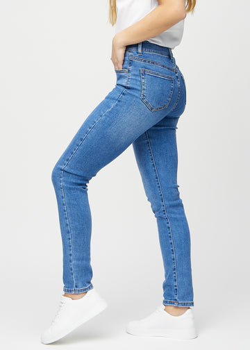 Slim jeans for women in blue, color Rivers. Side view on a model.