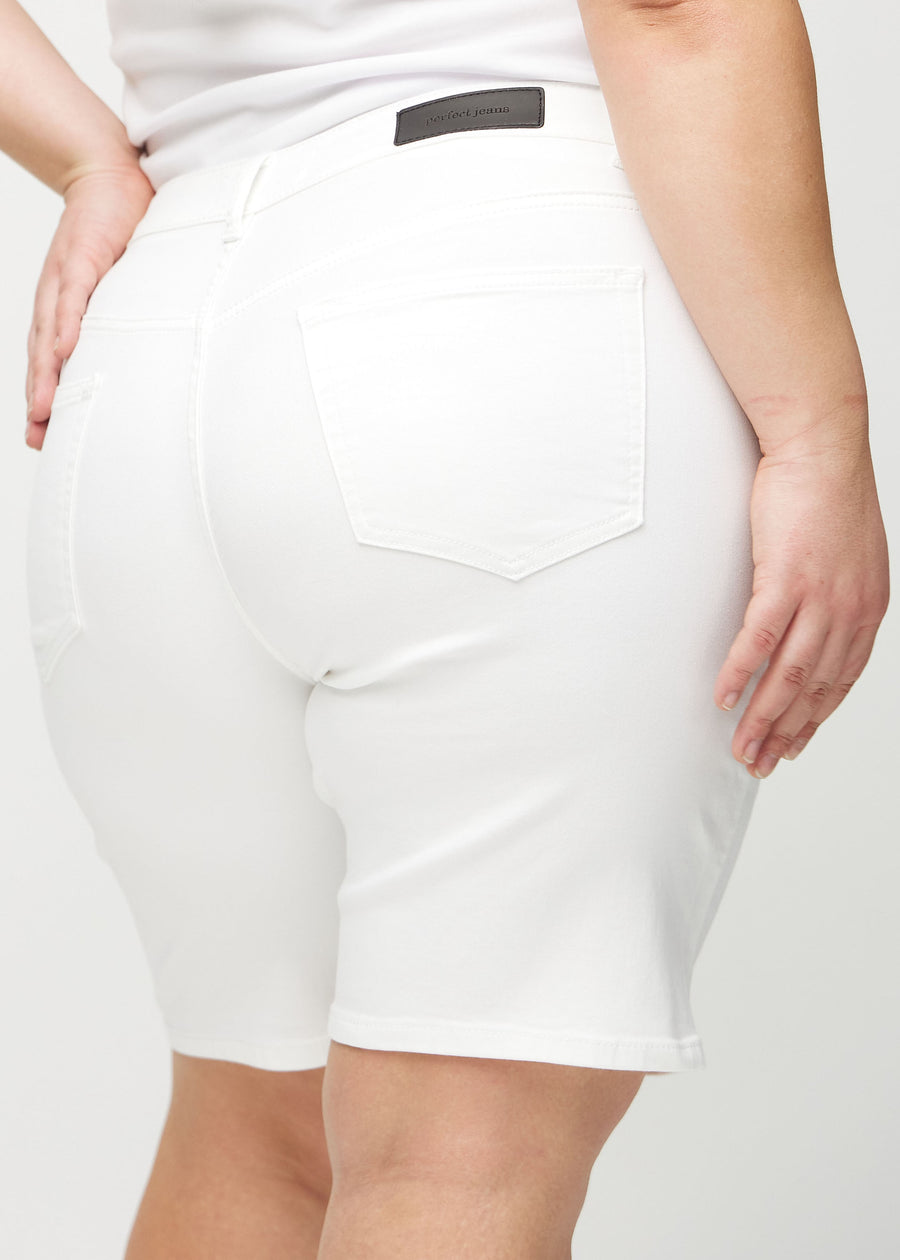 White regular middle shorts seen from the back close up on a plus-size model to show details.