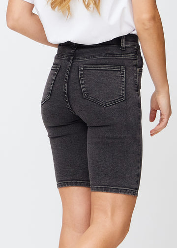 Dark grey denim skinny middle shorts seen from the back in close-up to show details.