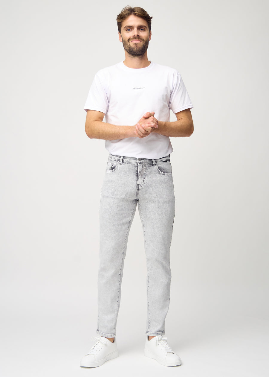 Full image of model in light grey denim regular jeans.