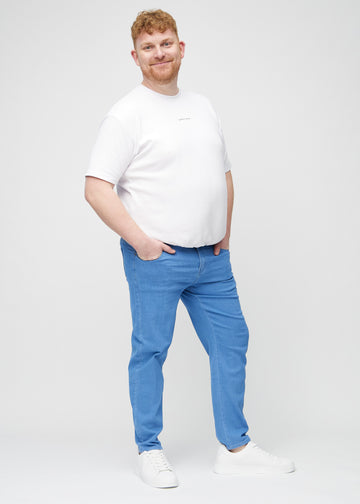 Full image of a plus-size model in blue regular jeans.