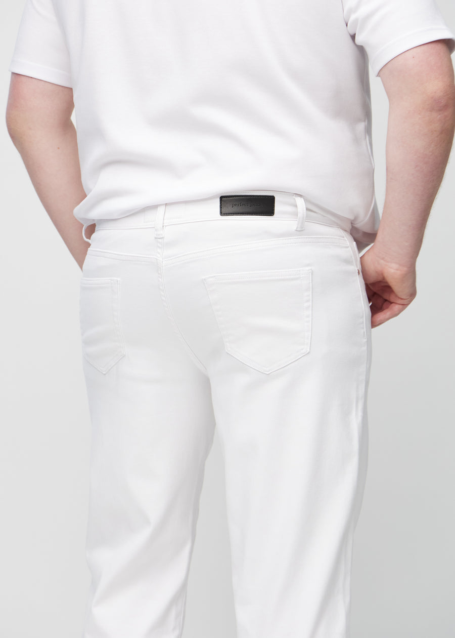 White regular jeans seen from the back close up on a plus-size model to show details.