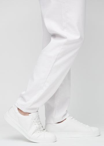 The ankles of a plus-size model, so you can see how loose the jeans fit.