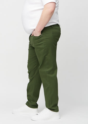 Dark green regular jeans seen from the side on a plus-size model.