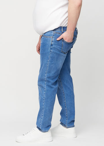 Denim regular jeans seen from the side on a plus-size model.