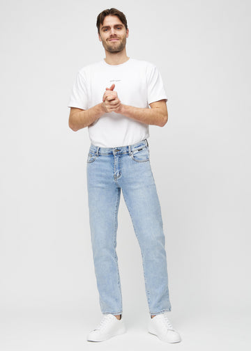 Full image of a model in light denim regular jeans.