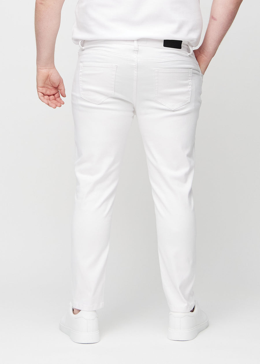White slim jeans viewed from the back on a plus-size model to show the full product.