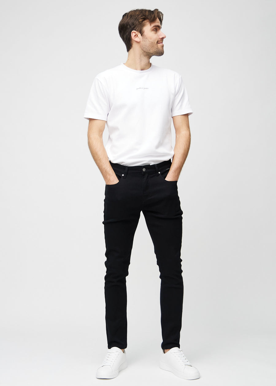 Full-length view of a model in black slim jeans.