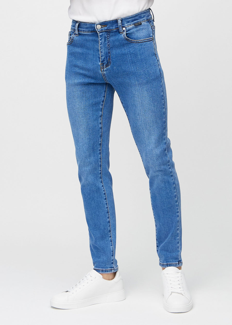 Blue denim slim jeans, model name Rivers, fitted closely along the legs , front view.