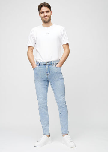Full-length view of a model in light blue denim slim jeans.