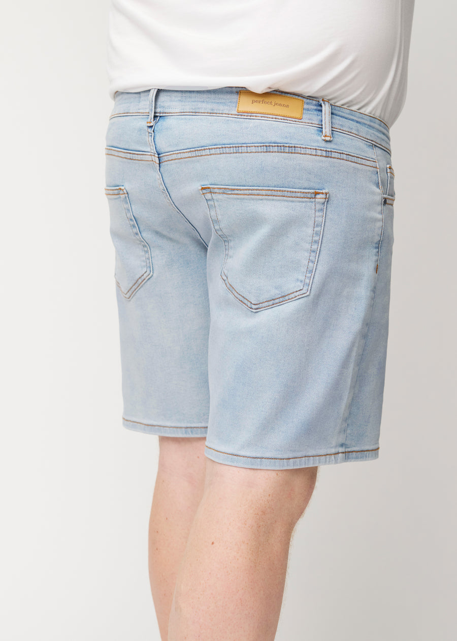 Light blue denim shorts for men in the colour Waves seen from the back up close on a plus-size model to show fit and details.