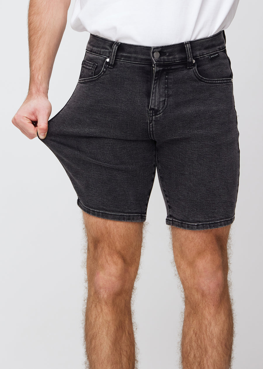 The model stretches the shorts at the thigh to show the stretch.